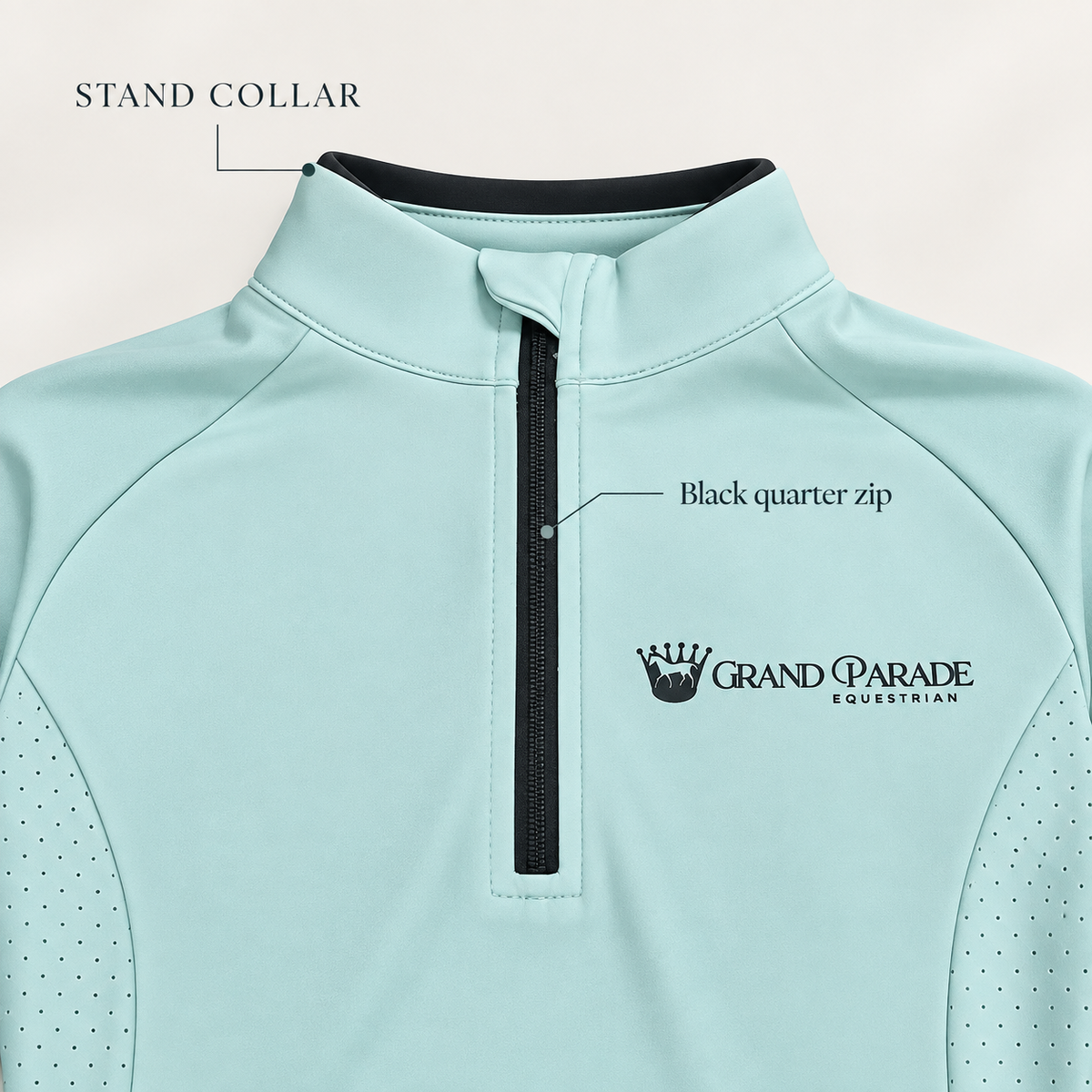 A close-up of a light mint green athletic quarter-zip pullover with black trim, featuring a stand collar, black quarter zipper, and the Grand Parade Equestrian logo on the chest.